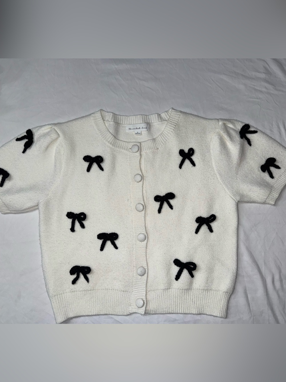 White Short-Sleeve Knit Cardigan with Black Bow Appliqués